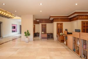 an empty lobby with a large room with a table at The Ritz-Carlton Tenerife, Abama in Guía de Isora