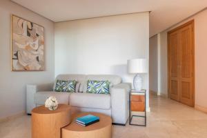a living room with a couch and a table at The Ritz-Carlton Tenerife, Abama in Guía de Isora