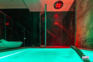 a swimming pool in a room with red lights at Abside Suite & Spa in Palermo