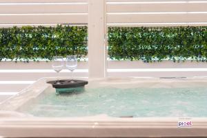 two wine glasses sitting in a bath tub at Abside Suite & Spa in Palermo