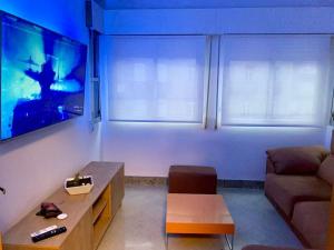 a living room with a couch and a tv at casa ribeiro in Ribadavia