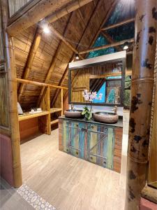 a large room with a wooden ceiling and a room with benches at Boscaje Solarpunk Habitat in La Gran Via