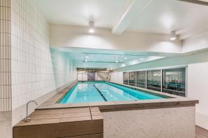 a swimming pool in a building at Brand New Luxe 3-Bed Apartment In Aotea Square in Auckland