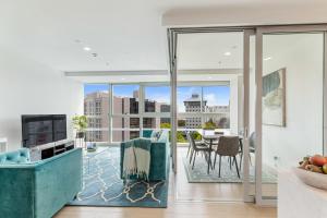 an open living room with a view of a city at Brand New Luxe 3-Bed Apartment In Aotea Square in Auckland