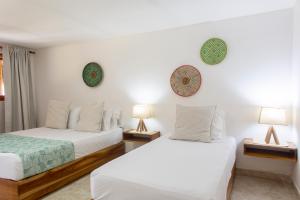 Postel nebo postele na pokoji v ubytování Hotel Isla del Sol