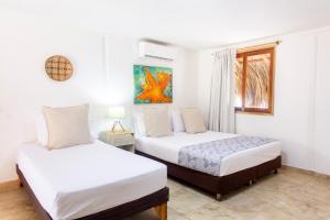 Postel nebo postele na pokoji v ubytování Hotel Isla del Sol