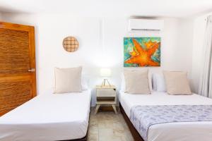 Postel nebo postele na pokoji v ubytování Hotel Isla del Sol