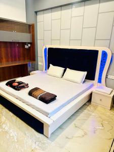 a bed in a room with a white and blue at The Grey House! in Noida