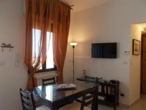 a dining room with a table and a window at Villa Il Melograno in Taormina