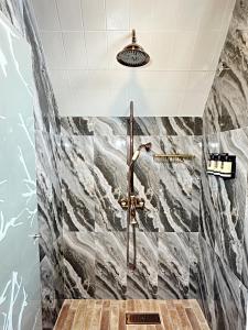 a bathroom with a shower with marble tiles at Boscaje Solarpunk Habitat in La Gran Via +39 photos
