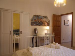 a bedroom with a bed and a painting on the wall at Villa Il Melograno in Taormina