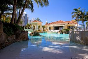 a swimming pool in front of a house at Mantra Towers of Chevron in Gold Coast