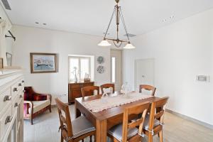 a kitchen and dining room with a table and chairs at Seafront, Luxury 2-BDR Townhouse in Andros