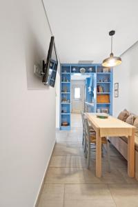 uma sala de jantar com uma mesa e um armário azul em Seafront, Luxury 2-BDR Townhouse em Andros