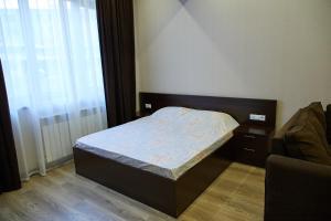 a small bedroom with a bed and a window at Residence North Avenue, Teryan 8. 14 2 in Yerevan