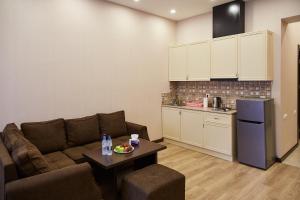 a living room with a couch and a kitchen at Residence North Avenue, Teryan 8. 14 2 in Yerevan
