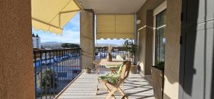 a balcony with a table and an umbrella at Green House in Montesilvano