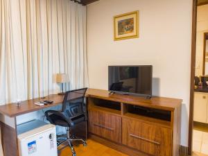 TV a/nebo společenská místnost v ubytování Pousada Casa de Charme