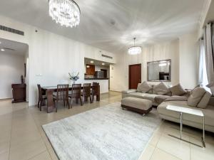 a living room with a couch and a dining room at JBR Beach, The Walk, 1-BDR with pool view in Dubai