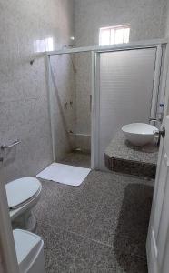 a bathroom with a shower and a toilet and a sink at Casa frida bacalar in Bacalar