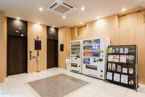a grocery store with a refrigerator in a room at Smile Hotel Hakataekimae in Fukuoka