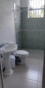 a bathroom with a sink and a toilet at Casa frida bacalar in Bacalar