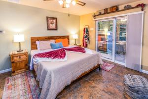 a bedroom with a large bed and a window at Cozy Cactus Resort sorta-kinda in Sedona