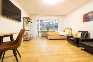 a living room with a bed and a couch at Homefeeling Apartment am Eisweiher Park in Pirmasens