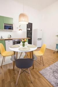 a kitchen with a table and chairs in a kitchen at Plan A in Budapest
