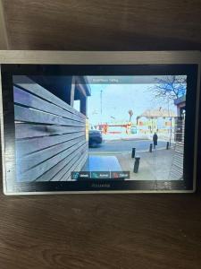 a television screen with a picture of a street at Luxury 1 bedroom Apartment in London overseeing Canary Wharf with free parking in London