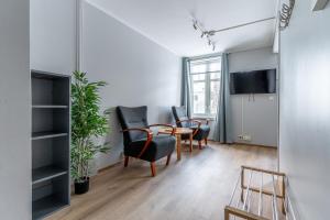 a living room with a table and chairs and a tv at Villa Svolvær in Svolvær