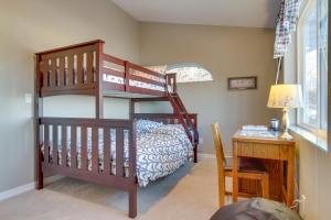 a bedroom with a bunk bed and a desk at Inviting Great Falls Home with Wraparound Deck! in Great Falls