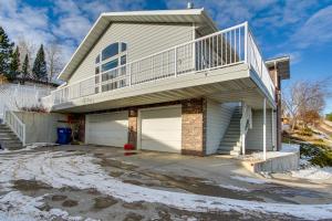 a house with a balcony and a garage at Inviting Great Falls Home with Wraparound Deck! in Great Falls
