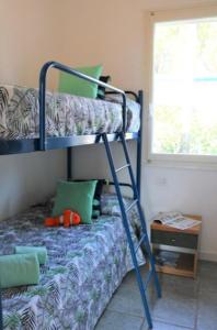 a bedroom with a bunk bed with a ladder at Cozy oasis for families-Beahost in Bibione