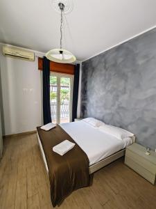 a bedroom with a bed and a large window at ETNAPARTMENT 3 in Giardini Naxos