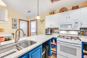 a kitchen with white cabinets and a sink at Downtown Williams Home Walk to Shops and Dining! in Williams