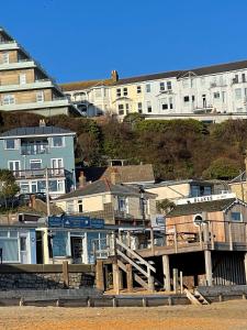 a group of houses and buildings on the beach at Sandy Toes - awesome beach view and access in Ventnor