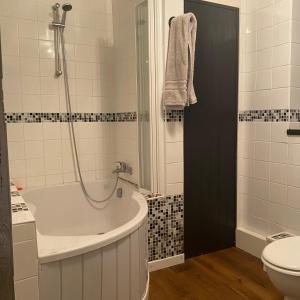 a bathroom with a tub and a toilet at Une maison à la campagne in Saint-Mars-sur-la-Futaie +11 photos