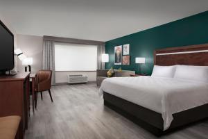 a hotel room with a large bed and a desk at Holiday Inn & Suites Durango Downtown by IHG in Durango +37 photos