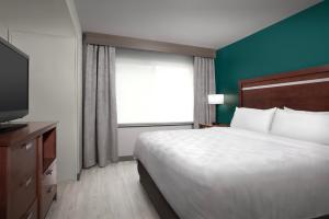 a hotel room with a bed and a television at Holiday Inn & Suites Durango Downtown by IHG in Durango