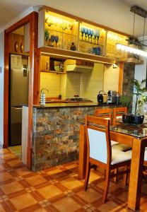 a kitchen with a table and chairs and a refrigerator at Portugal L y D in Santiago
