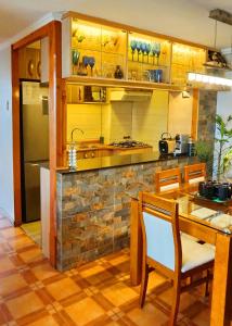 a kitchen with wooden cabinets and a table and chairs at Portugal L y D in Santiago