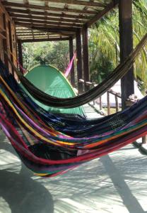 a hammock with a tent in the background at CATEDRAL THE ROCK CAMPING in Presidente Figueiredo