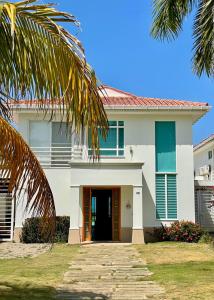 a large white house with a driveway at casa moderna con playa cartagena in Cartagena de Indias