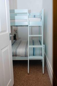 a white bunk bed with a ladder in a room at THE CHADWICK in Skegness