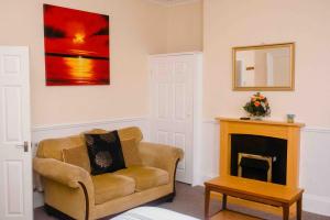 a living room with a chair and a fireplace at THE CHADWICK in Skegness