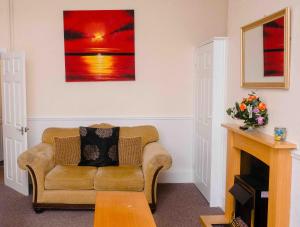 a living room with a couch and a painting on the wall at THE CHADWICK in Skegness