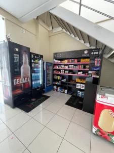 a store with two large monitors in a room at Flat Biarritz Próximo a Praia - Fonseca Imóveis in São Luís