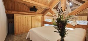a room with a table with a vase of flowers at Quinta de Sito in Chantada