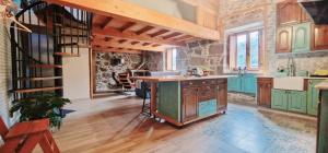 a kitchen with green cabinets and a wooden island at Quinta de Sito in Chantada